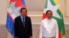 Cambodian Prime Minister Hun Sen, left, poses for photographs together with Myanmar State Administration Council Chairman, Senior General Min Aung Hlaing, right, before holding a meeting in Naypyitaw, Myanmar, Friday, Jan. 7, 2022. 