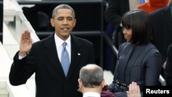 U.S. President Barack Obama is sworn in by Supreme Court Chief of Justice John Roberts, as first lady Michelle Obama looks on during inauguration ceremonies in Washington, D.E., January 21, 2013.