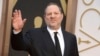 FILE - Harvey Weinstein arrives at the Oscars in Los Angeles, California, March 2, 2014. Weinstein has been fired from The Weinstein Co., effective immediately, following new information revealed regarding his conduct, the company's board of directors announced Oct. 8, 2017.