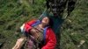 A woman, injured in Saturday’s earthquake, is carried on a stretcher after being evacuated from Melamchi in an Indian Air Force helicopter, at the airport in Kathmandu, Nepal, May 1, 2015. 