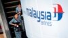 A Malaysia Airlines flight crew heads for the departure lounge at Kuala Lumpur International Airport. Malaysian civil aviation authorities officially declared the airline's Flight MH370 crash an accident on Jan. 29, 2015.
