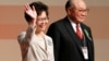 Carrie Lam waves after she won the election for Hong Kong's next Chief Executive as Woo Kwok-hing stands next to her in Hong Kong, March 26, 2017. 