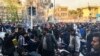 FILE - In this photo taken by an individual not employed by the Associated Press and obtained by the AP outside Iran, demonstrators gather to protest against Iran's weak economy, in Tehran, Iran, Dec. 30, 2017.