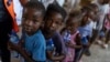 Children line up for food at a shelter for families displaced by gang violence in the Tabarre neighborhood of Port-au-Prince, Haiti, on May 19, 2024. UNICEF this week warned that violence, mass displacement, epidemics and malnutrition are breaking Haiti's health care system.
