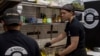 The workers of White Burger restaurant prepare an order in Kramatorsk, Ukraine, Wednesday, Sept. 13, 2023. A Gallup poll released Oct. 26, 2023, said most Ukrainians are optimistic about the future.