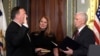 Vice President Mike Pence, right, swears in CIA Director Mike Pompeo, left, as Pompeo's wife Susan, center, holds the Bible in the Vice President's Ceremonial Office in the Eisenhower Executive Office Building in the White House complex in Washington, Jan. 23, 2017.