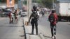 FILE - National police officers patrol an intersection in Port-au-Prince, Haiti, Aug. 5, 2023. Kenya has offered to send a police force to help combat gang violence in the Caribbean nation. 
