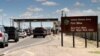 FILE -- Cars wait to enter Fort Bliss in El Paso, Texas.
