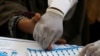 A medical worker helps a woman to draw blood for a HIV test at the free medical camp in Ratodero, Pakistan May 25, 2019. (REUTERS/Akhtar Soomro)