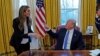 FILE - U.S. President Donald Trump confers with White House Communications Director Hope Hicks, at the White House in Washington, January 17, 2018. 