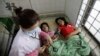 A Cambodian doctor checks blood pressure of patients at Preah Kossamak Hospital in Phnom Penh, Cambodia, file photo. (AP Photo/Sakchai Lalit)