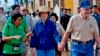 In this photo taken November 21, 2009 released by Habitat for Humanity, former U.S. President Jimmy Carter, right, holds the hand of his wife Rosalynn as they visit the Damnak Thom village where Habitat for Humanity volunteers built 21 houses.