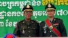 FILE PHOTO: Cambodia's Prime Minister Hun Sen (L) poses with his son Hun Manet on the outskirts of Phnom Penh on October 13, 2009. REUTERS/Chor Sokunthea