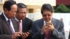 Senior Cambodian government officials are using their smart phones while awaiting the return of Cambodian Prime Minister Hun Sen from France at Phnom Penh International Airport, October 28, 2015. Government officials and state institutions have recently taken to Facebook to inform the public as the social media platform is becoming increasingly popular among Cambodian youth. (Hean Socheata/VOA Khmer) 
