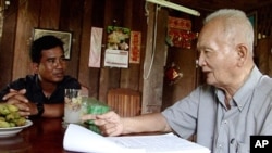 Thet Sambath, filmmaker of the 'Enemies of the People', speaking to former Khmer Rouge leader Nuon Chea. 