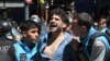 Police detain a protester during an anti-government demonstration against the economic reforms of President Javier Milei in Buenos Aires, Argentina, Dec. 27, 2023.