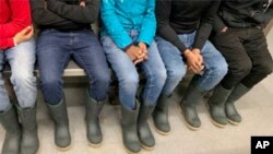 An undated mage released by the U.S. Attorney’s Office shows how a group of migrants were dressed when they crossed the Canada-US border on a night temperatures reached minus 36 Fahrenheit (minus 38 Celsius)
