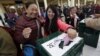 Tibetan exiles react as they cast their vote during the elections for the Tibetan government-in-exile at a polling booth in Dharamsala, India, March 20, 2016. 