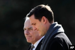 FILE - Then-White House staff secretary Rob Porter, right, walks with White House Chief of Staff John Kelly to board the Marine One on the South Lawn as they leave the White House in Washington, Feb. 2, 2018.