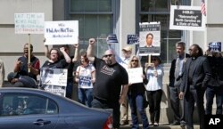 FILE - Opponents of House Bill 2 protest across the street from the North Carolina State Capitol in Raleigh, North Carolina, April 11, 2016.