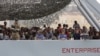 Migrants arrive on the British vessel HMS Enterprise before disembarking in the Sicilian harbor of Catania, Italy, Oct. 6, 2015. The Italian coastguard said on Tuesday some 1830 migrants were rescued from the Mediterranean sea in a twenty-four hour period