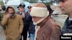 FILE - A screengrab taken from a video shows mafia boss Matteo Messina Denaro being escorted out of a Carabinieri police station after he was arrested in Palermo, Italy, Jan. 16, 2023. (Carabinieri/Handout via Reuters)