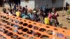 FILE - People celebrate as they are released from Ebola quarantine in the village of Massessehbeh on the outskirts of Freetown, Sierra Leone, Aug. 14, 2015.