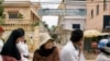 Cambodians and Muslims ride on a motor-cart past a catholic church in Phnom Penh, Cambodia, Tuesday, July 17, 2007. 