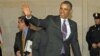 President Barack Obama waves to members of the media as he heads to a meeting with House Democratic Caucus on Capitol Hill in Washington, March 14, 2013.