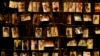 FILE - Family photographs of some of those who died hang on display in an exhibition at the Kigali Genocide Memorial centre in the capital Kigali, Rwanda, April 5, 2019. 