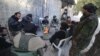 Rebel fighters of al-Jabha al-Shamiya (Levant Front) warm themselves around a fire near the justice palace in the old city of Aleppo, Syria, Jan. 28, 2016. 