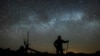 In this file photo, Dave Cooke observes the Milky Way over a frozen fish sanctuary in central Ontario, north of Highway 36 in Kawartha Lakes, Ontario, Canada, early Sunday, March 21, 2021. (Fred Thornhill/The Canadian Press via AP)