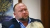Conspiracy theorist Alex Jones answers questions about his emails asked by Mark Bankston, lawyer for Neil Heslin and Scarlett Lewis, during trial at the Travis County Courthouse in Austin, Aug. 3, 2022. 