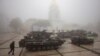 FILE - A man walks past destroyed Russian military vehicles outside St. Michael's Golden-Domed Monastery on a foggy morning, amid Russia's attack on Ukraine, in Kyiv, Ukraine October 21, 2023. 