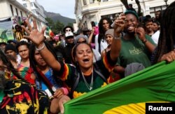 FILE - A protester carries a marijuana pipe during a march calling for the legalization of cannabis in Cape Town, South Africa, May 7, 2016.