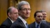 Apple CEO Tim Cook, center, is surrounded by his team during a break from testifying on Capitol Hill in Washington, May 21, 2013. 