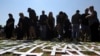 FILE - People place crosses, symbolically representing farmers killed in the country, at a ceremony at the Vorrtrekker Monument in Pretoria, South Africa, Oct. 30, 2017. U.S. President Donald Trump has tweeted that he has asked the Secretary of State Mike Pompeo to "closely study the South African land and farm seizures and expropriations and the large scale killing of farmers." South Africa has responded that Trump is "misinformed."