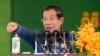 Cambodia's Prime Minister Hun Sen speaks to garment workers during a visit to a factory outside Phnom Penh, Cambodia, Wednesday, Aug. 30, 2017. Hun Sen is on a country-wide trip visiting the nation's factory workers to hear their hopes and concerns in person. (AP Photo/Heng Sinith)