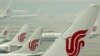 FILE- Air China planes are seen on the tarmac of the Beijing Capital International Airport, July 11, 2011. 