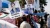 A supporter of Egypt's Islamist President Mohamed Morsi in front pictures of Morsi at Nasr City, where protesters have installed their camp and hold their daily rally, in Cairo, Egypt, July 25, 2013.