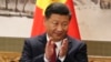 Chinese President Xi Jinping claps while addressing the media as he introduces new members of the Politburo Standing Committee at Beijing's Great Hall of the People Wednesday, Oct. 25, 2017.
