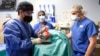Members of the surgical team show the pig heart for transplant into patient David Bennett in Baltimore, Jan. 7, 2022, in this photo provided by the University of Maryland School of Medicine.