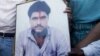 Family members of Sarabjit Singh hold his picture to appeal for his release during a demonstration in the northern Indian city of Amritsar June 25, 2009. Pakistan's Supreme Court dismissed on Wednesday an appeal by Singh, an Indian man seeking a review of