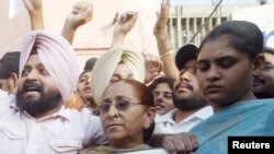 Family members of Sarabjit Singh hold his picture to appeal for his release during a demonstration in the northern Indian city of Amritsar June 25, 2009. Pakistan's Supreme Court dismissed on Wednesday an appeal by Singh, an Indian man seeking a review of