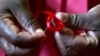 A Kenyan woman prepares ribbons ahead of World Aids Day at Beacon of Hope centre, a non-government organization formed to address women's problem of HIV/AIDS in Nairobi, November 25, 2004.