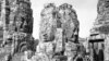 Brooding stone faces look down on the Bayon Temple in the ruins of Angkor, the ancient capital of the Khmer Empire in Cambodia on July 5, 1960. The identical faces, all bearing the same smile, are said to be symbols of Jayavarman VII, the last great build