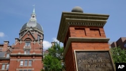 A sign stands in front of part of the Johns Hopkins Hospital complex, July 8, 2014, in Baltimore. Most medical students at Johns Hopkins University will no longer pay tuition thanks to a $1 billion gift from Bloomberg Philanthropies. 