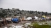 Syrian civilians flee from Idlib in rain toward the north to find safety inside Syria near the border with Turkey, Feb. 13, 2020. 