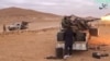 A still image taken from a video released by Islamic State-affiliated Amaq news agency Dec. 10, 2016, purports to show Islamic State fighters advancing over the Hayan mountain south of Palmyra, Syria. 