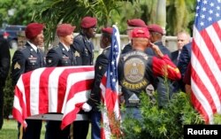 FILE - An honor guard carries the coffin of U.S. Army Sergeant La David Johnson, who was among four Special Forces soldiers killed in Niger, at a graveside service in Hollywood, Fla., Oct. 21, 2017.
